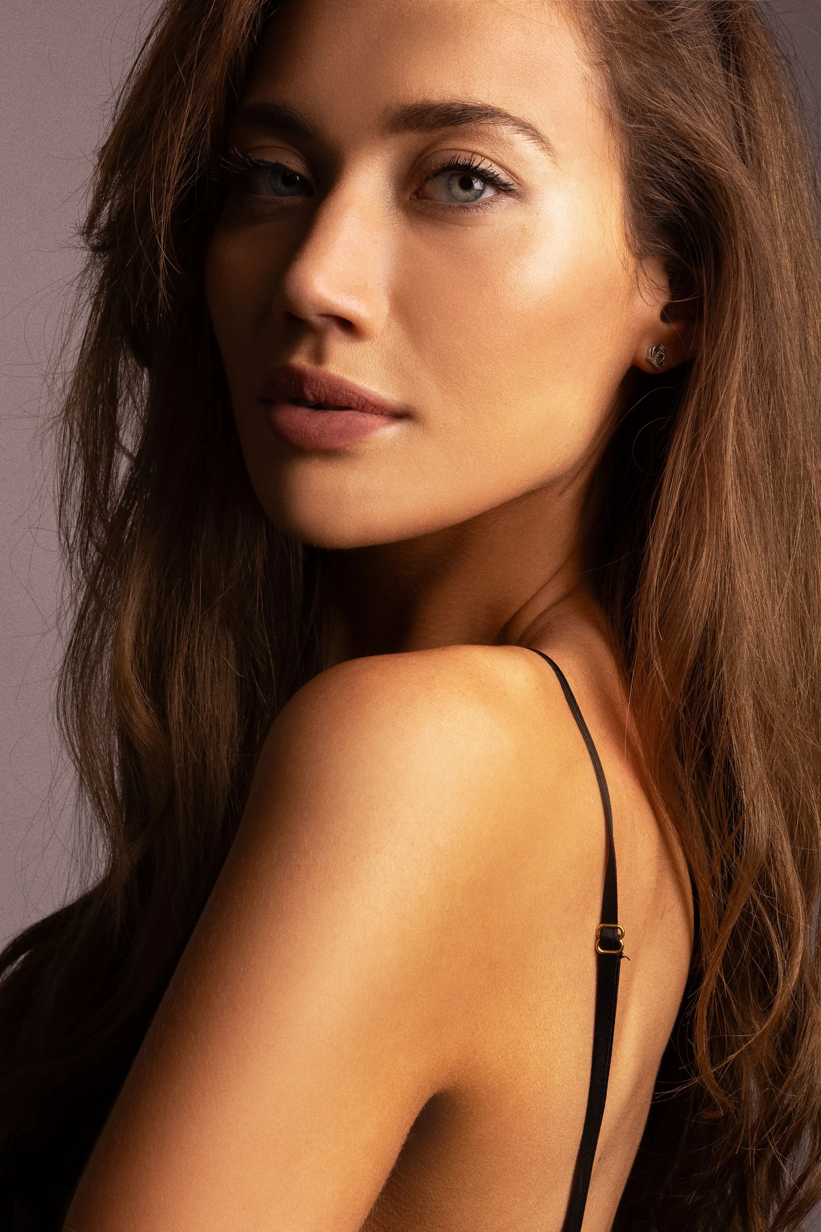 Warm studio beauty portrait of Nataša looking over her shoulder